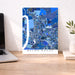 Map of Baton Rouge on a desk with a laptop and plant