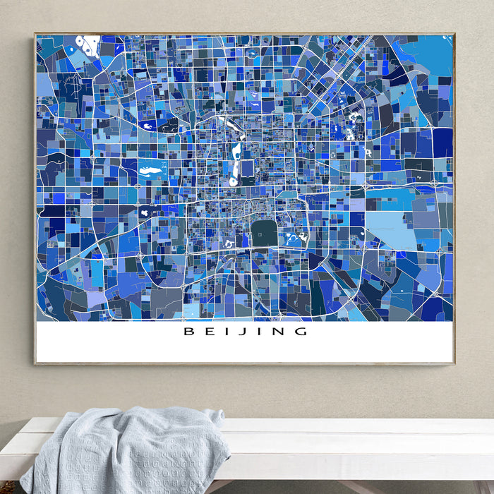 Framed map of Beijing with a geometric design on a wall.