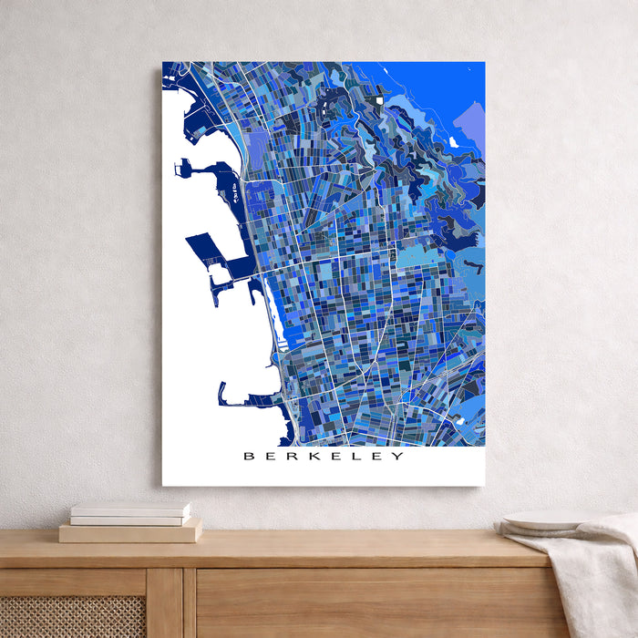 Map of Berkeley in blue tones on a white wall above a wooden surface.