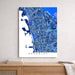 Map of Berkeley in blue tones on a white wall above a wooden surface.