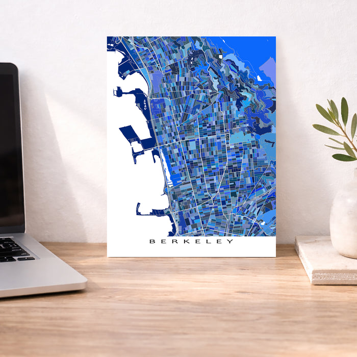 Map of Berkeley on a desk with a laptop and plant