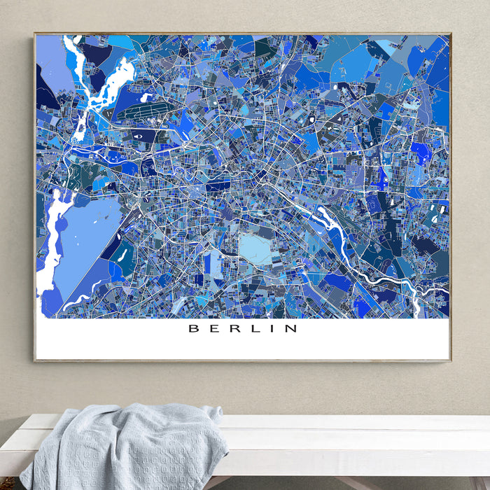 Framed map of Berlin on a wall above a white surface with a gray towel.