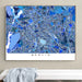 Framed map of Berlin on a wall above a white surface with a gray towel.
