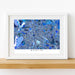 Framed map of Berlin with a blue color scheme on a white wall.
