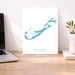 Desk with a laptop, plant, and a map of Bermuda on a white background