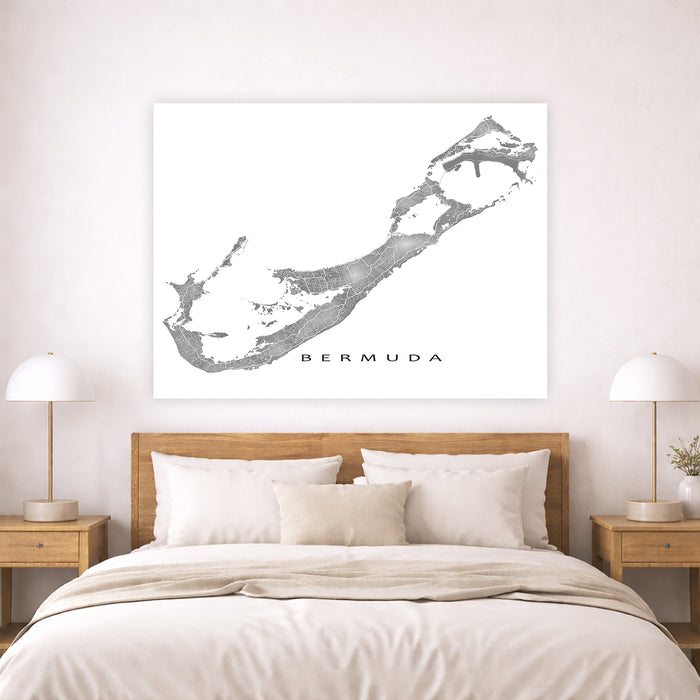 Map of Bermuda on a wall above a bed in a bedroom setting