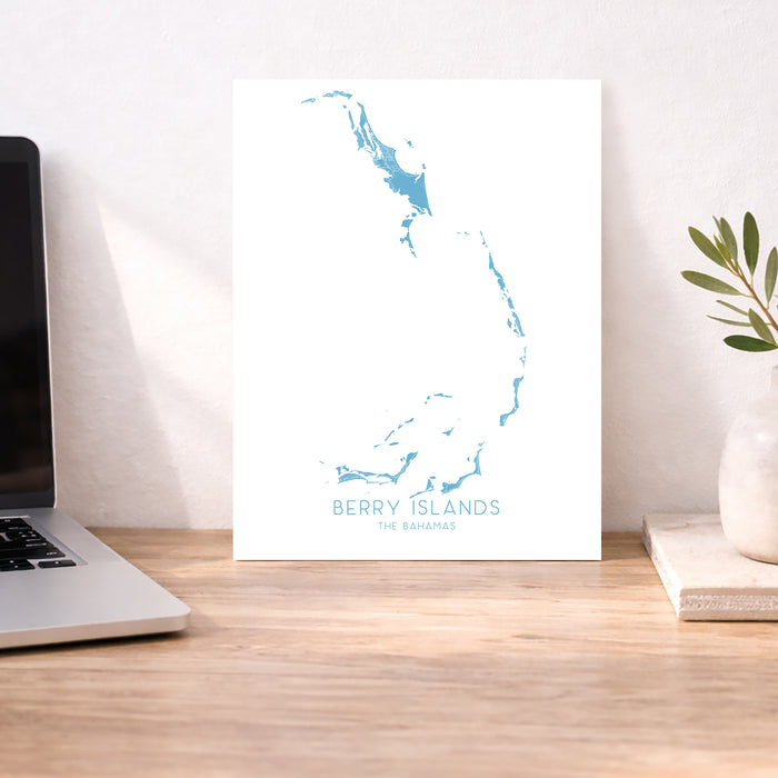Map of Berry Islands on a desk with a laptop and plant