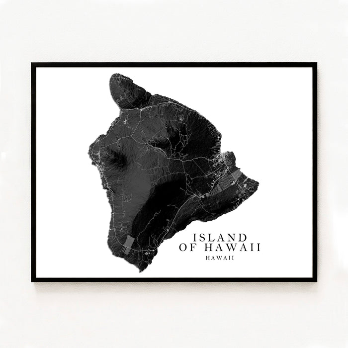 Framed black and white map of the Island of Hawaii on a white wall.