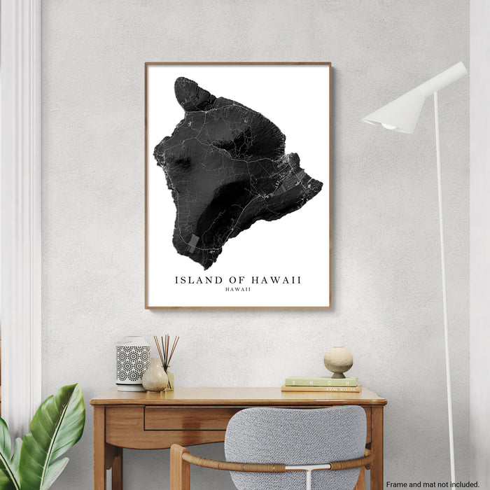 Framed map of the Island of Hawaii on a wall above a desk.