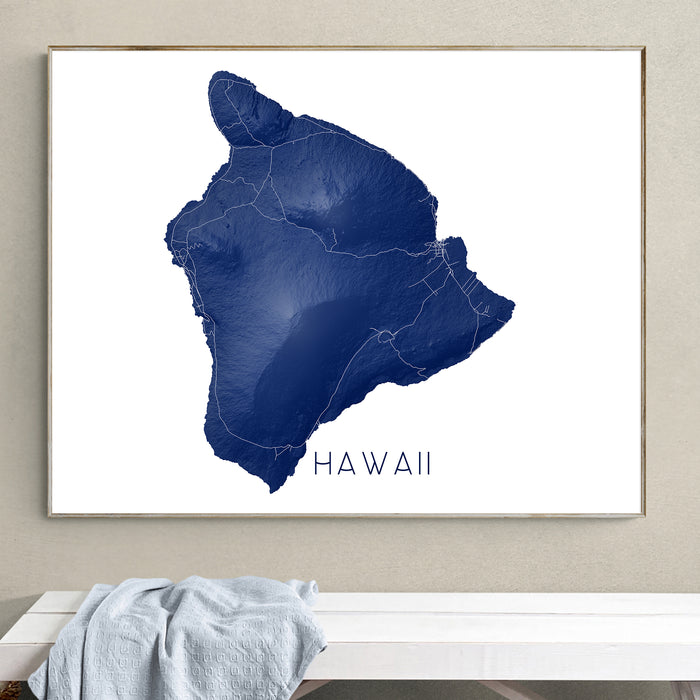 Framed map of Hawaii on a wall above a white bench.