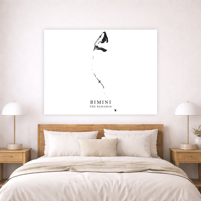 A minimalist black ink-style wall art print featuring a stylized calligraphic figure and the text 'BIMINI THE BARBARAS' on a white canvas, displayed above a neatly made bed in a modern bedroom setting.