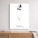 A minimalist black and white shark poster titled 'BIMINI THE BAHAMAS' hanging on a light gray textured wall above a wooden console table with books and a throw blanket.