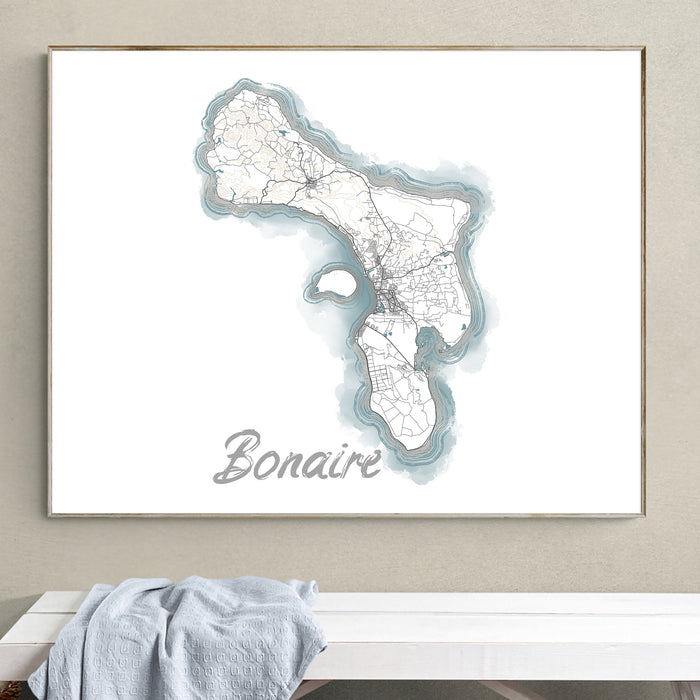 Framed map of Bonaire on a wall above a white surface with a towel.