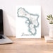 Map of Bonaire on a desk with a laptop and plant