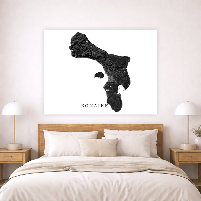 Map of Bonaire on a wall above a bed in a bedroom setting