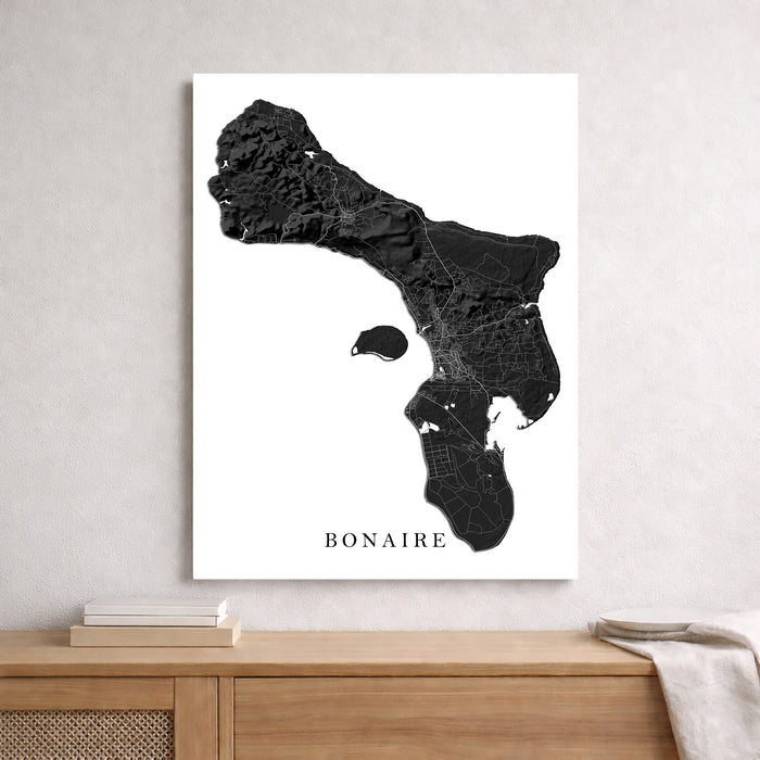Map of Bonaire on a white background in a frame, displayed on a wooden surface.