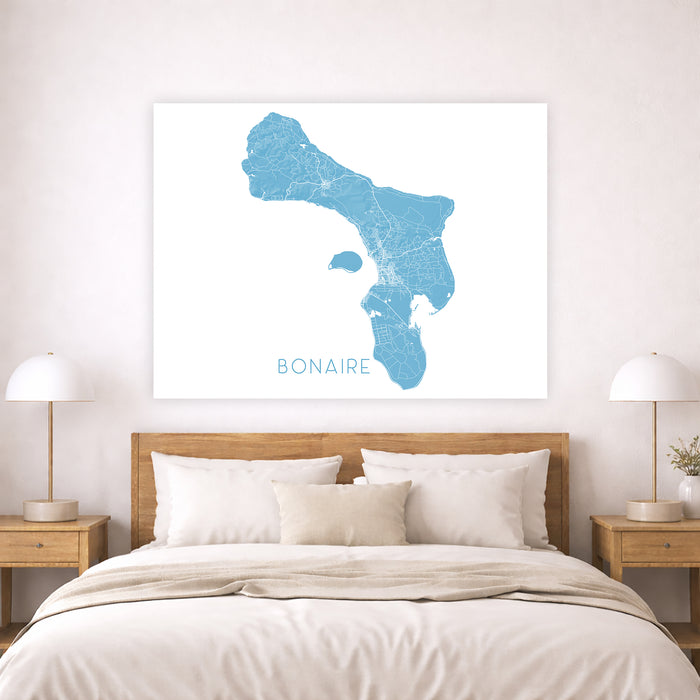 Map of Bonaire on a wall above a bed in a bedroom
