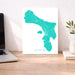 Map of Bonaire on a desk with a laptop and plant