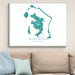 Framed map of Bora Bora on a wall above a beige sofa with light blue pillows.