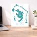 Map of Bora Bora on a desk with a laptop and plant