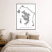 Framed map of Bora Bora on a wall above a bed in a bedroom.
