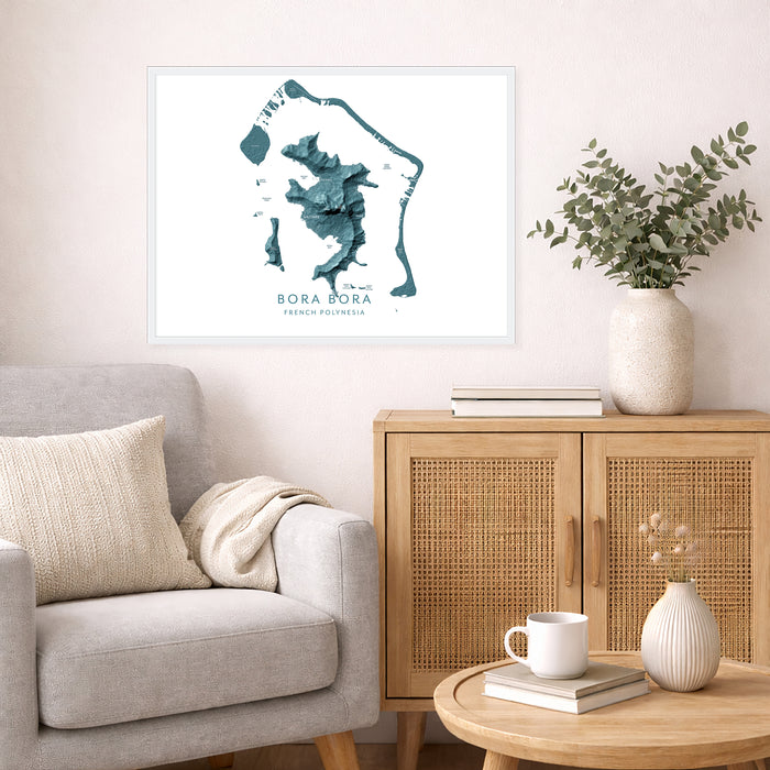Living room with a gray sofa, wooden cabinet, and decorative items including a framed map of Bora Bora.