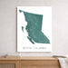 Map of British Columbia on a white wall above a wooden shelf.