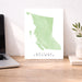Map of British Columbia on a desk with a laptop and plant