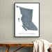 Framed map of British Columbia on a wall above a wooden bench.