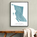 Framed map of British Columbia on a wall above a wooden bench.