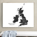 A framed black-and-white map print of the British Isles hangs on a beige wall above a white bench with a light blue cloth draped over it.