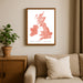 Framed map of the British Isles on a wall above a sofa with a plant beside it.