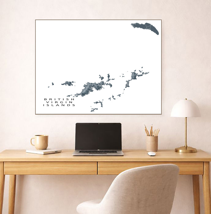 Framed map of British Virgin Islands above a desk with a laptop and mug.