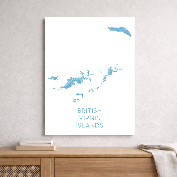 Map of British Virgin Islands on a white wall above a wooden shelf.