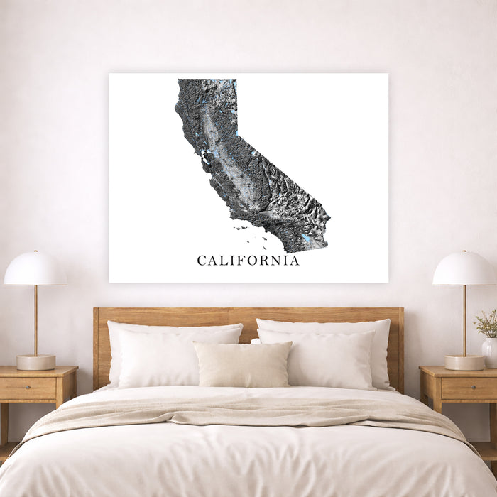 Framed map of California above a bed in a bedroom setting