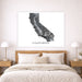 Framed map of California above a bed in a bedroom setting