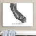 Framed map of California on a wall above a white bench.