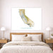Framed map of California above a bed in a bedroom setting