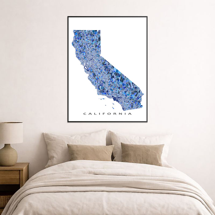 Framed map of California on a wall above a bed
