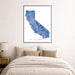 Framed map of California on a wall above a bed
