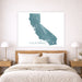 Framed map of California on a wall above a bed with wooden headboard and nightstands.