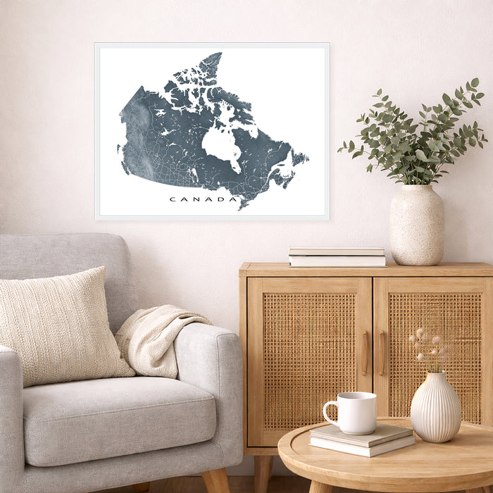 Living room with a map of Canada on the wall, a couch, and a wooden cabinet.