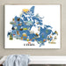 Framed map of Canada with various animals and landmarks on a wall.