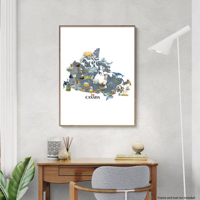 Framed map of Canada with animals on a wall above a desk.