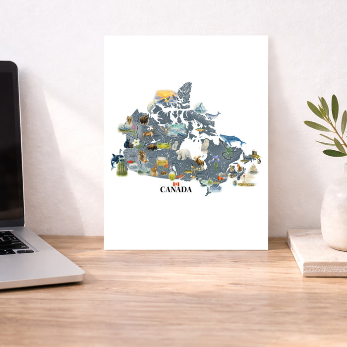 Map of Canada with animals on a desk next to a laptop