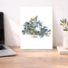 Map of Canada with animals on a desk next to a laptop