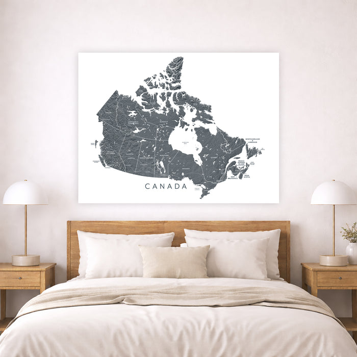 Map of Canada on a wall above a bed in a bedroom setting