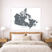 Map of Canada on a wall above a bed in a bedroom setting