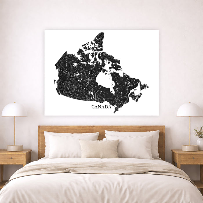 Map of Canada on a wall above a bed in a bedroom setting