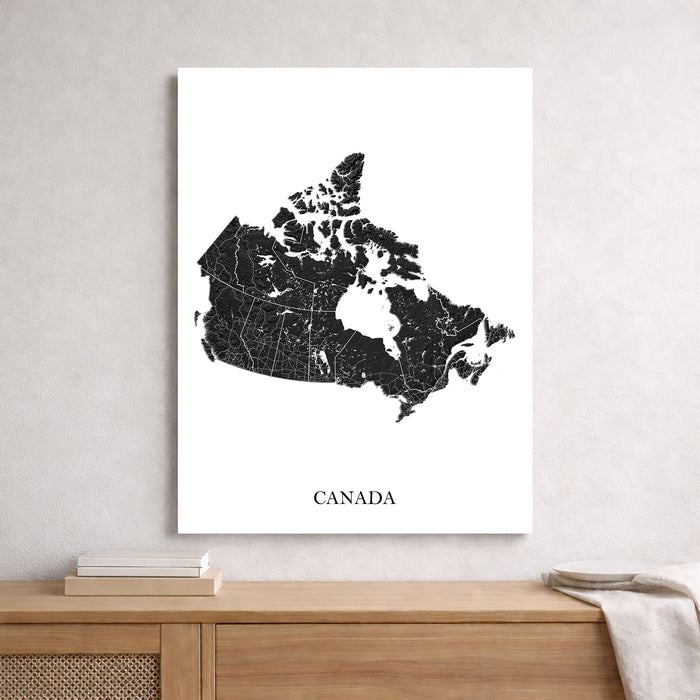 Map of Canada on a white wall above a wooden shelf.